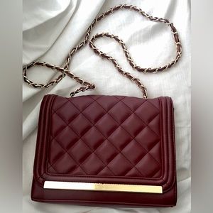 Burgundy Colored Crossbody Bag with Gold Chain Strap and Floral Print Interior